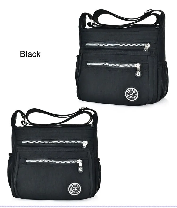 New women's Nylon cross body water repellant bag in Black! Tons of storage space with 5 zippered pouches